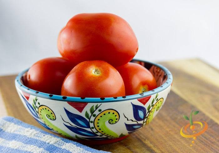 Tomato - Rutgers Seeds | Bowl of medium-sized bright red Rutgers tomatoes with smooth skin on wooden surface