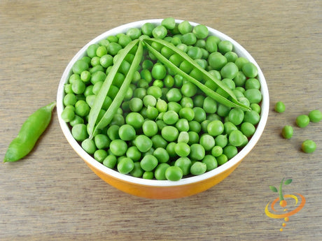 Bowl of fresh green peas with open pea pods on wooden surface, Little Marvel seeds
