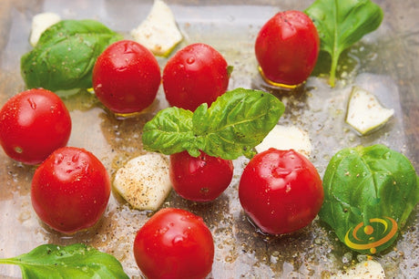 Red cherry tomato seeds from SeedsNow, small indeterminate tomato variety, shown in close-up with ripe red cherries.