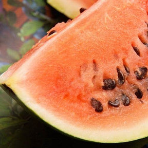 Close-up of a slice of Watermelon Black Diamond showing red flesh and black seeds